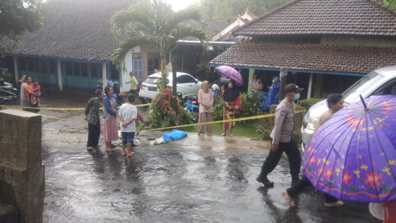 Polisi memasang garis dilarang melintas di lokasi penemuan bocah tewas.