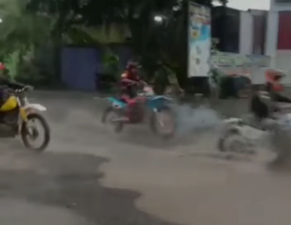Sejumlah motor trail melintas di kubangan jalan Desa Tapen Lor, Jombang.