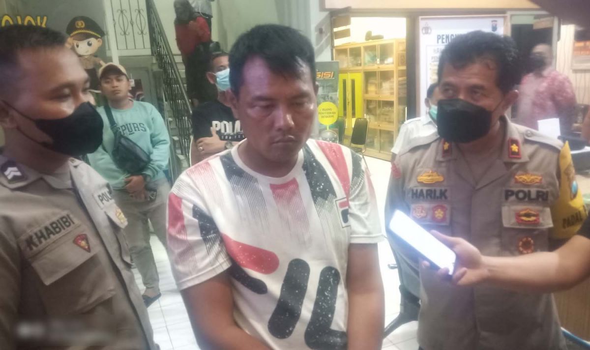 Sopir angkot pelaku pelecehan seksual terhadap dua siswi SMA saat diamankan di Mapolsek Asemrowo, Surabaya (Foto: Zain Ahmad/jatimnow.com)