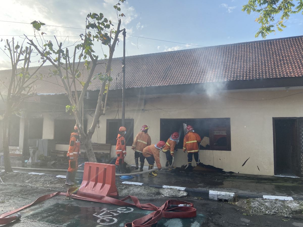 Petugas berusaha memadamkan api di gudang perlengkapan Satuan Samapta Bhayangkara Polres Kediri Kota. (Foto-foto: Yanuar Dedy/jatimnow.com)