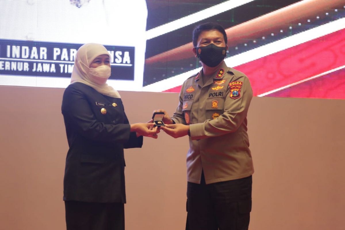 Gubernur Khofifah saat menerima pin emas dan penghargaan dari Kapolri melalui Kapolda Jatim. (Foto: Zain Ahmad/jatimnow.com)