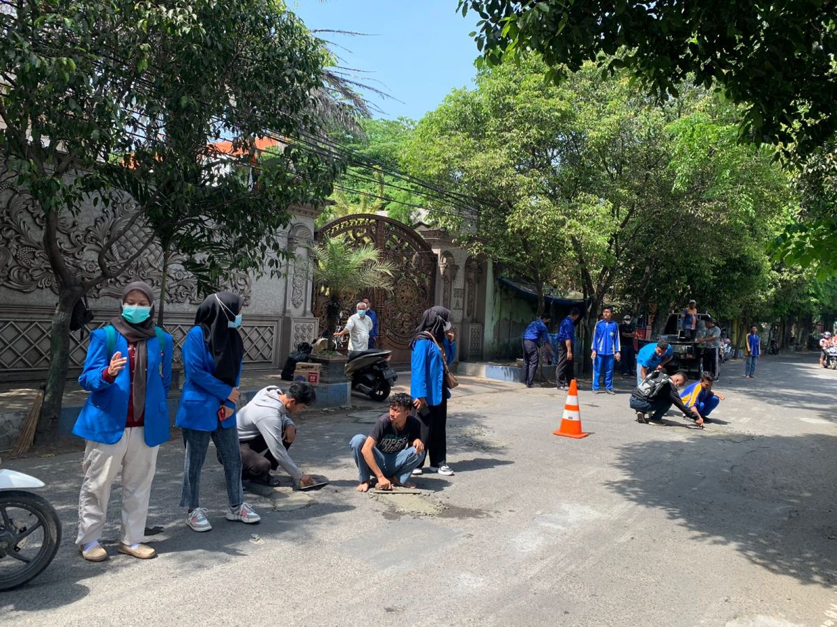 Mahasiswa tambal jalan berlubang di Pasuruan.(Foto: Humas Yayasan Yadika)