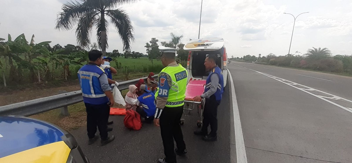 Petugas kepolisian saat mengevakuasi penumpang mobil yang kecelakaan. (Sat PJR Ditlantas Polda Jatim for jatimnow.com)