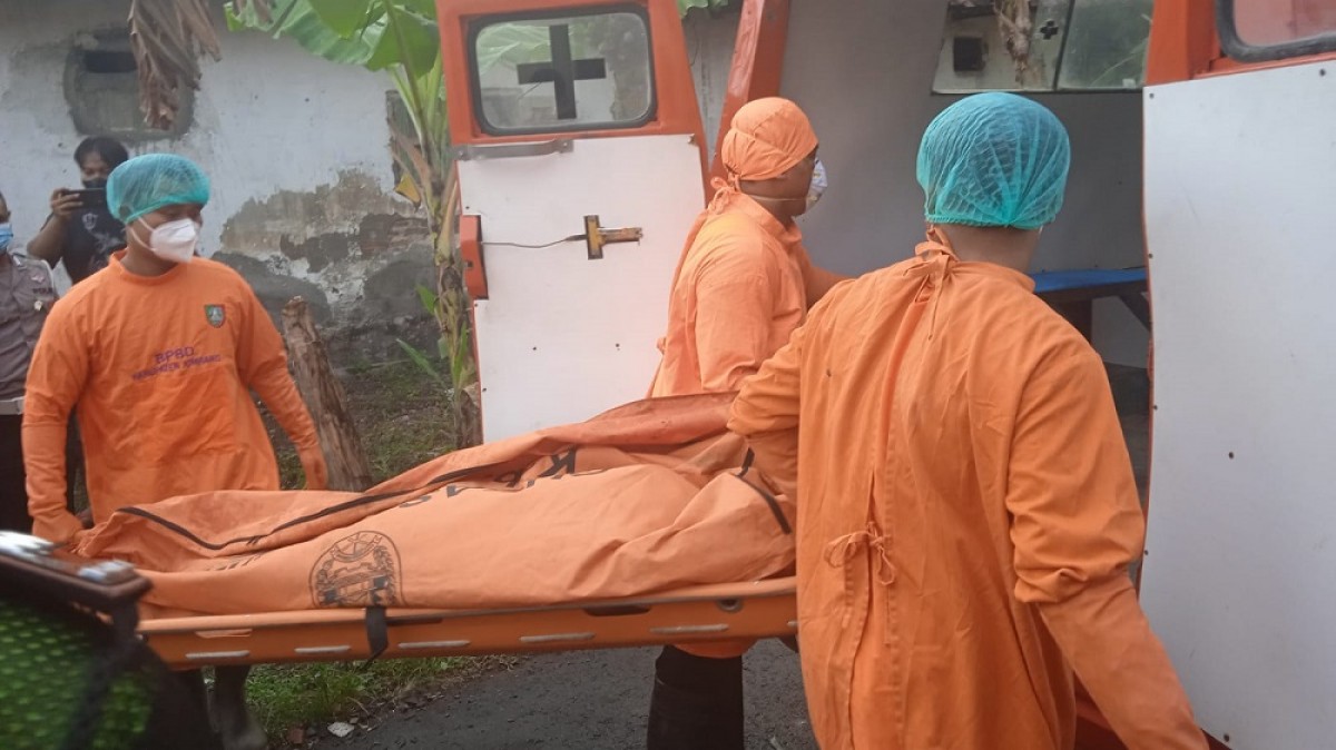 Petugas saat mengevakuasi jenazah ke dalam ambulans. (Foto: Polsek Mojoagung)