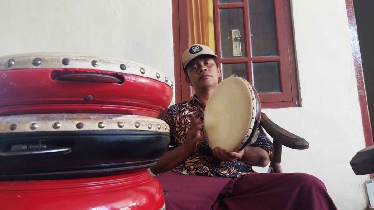 Cak Imik (51) bersama rebana buatannya. (Foto: Eko Purwanto/jatimnow.com)