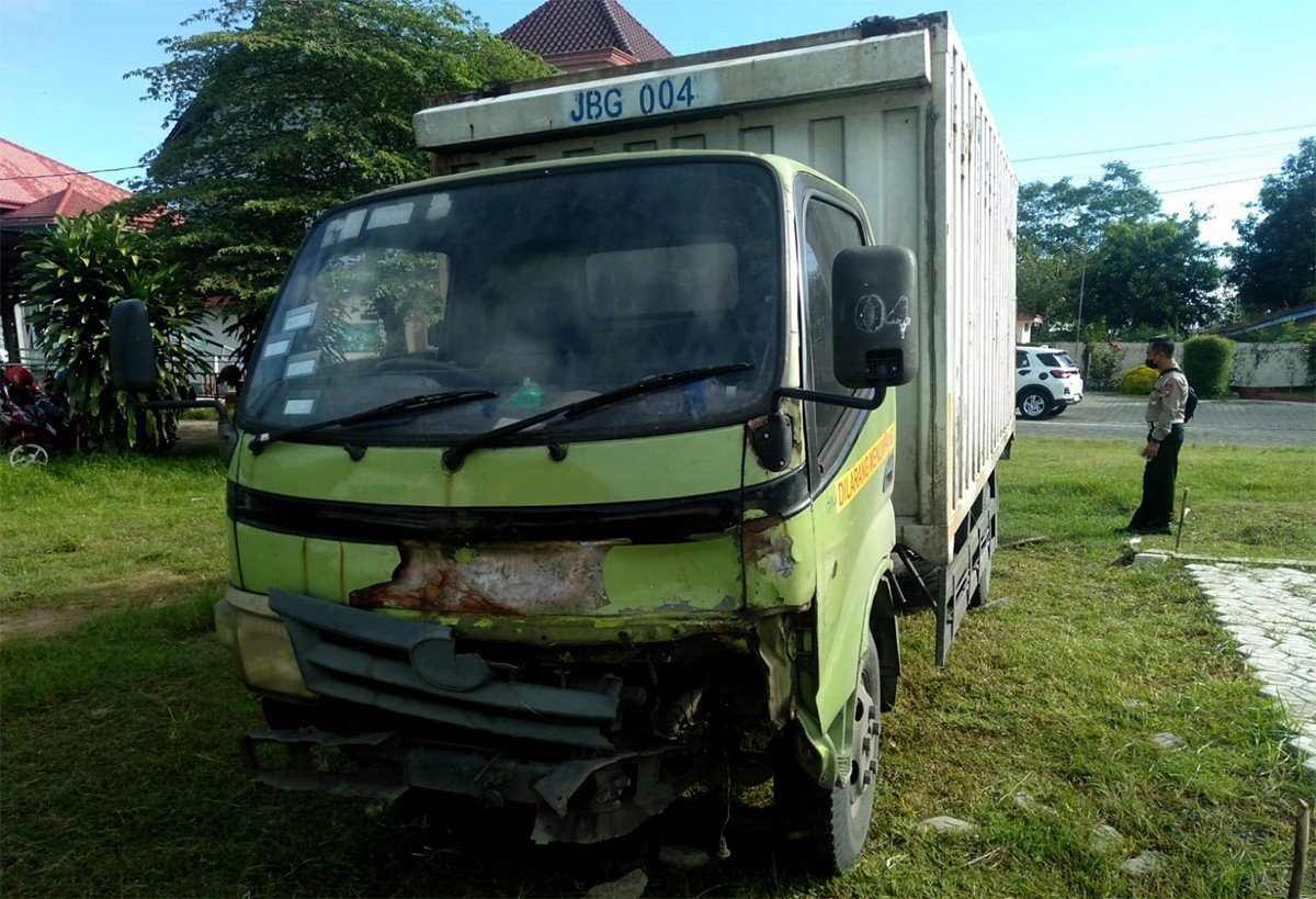 Kondisi truk box milik Indomaret yang rusak bagian depan usai menabrak sepeda motor pedagang ayam. (foto: Elok Aprianto/jatimnow.com)