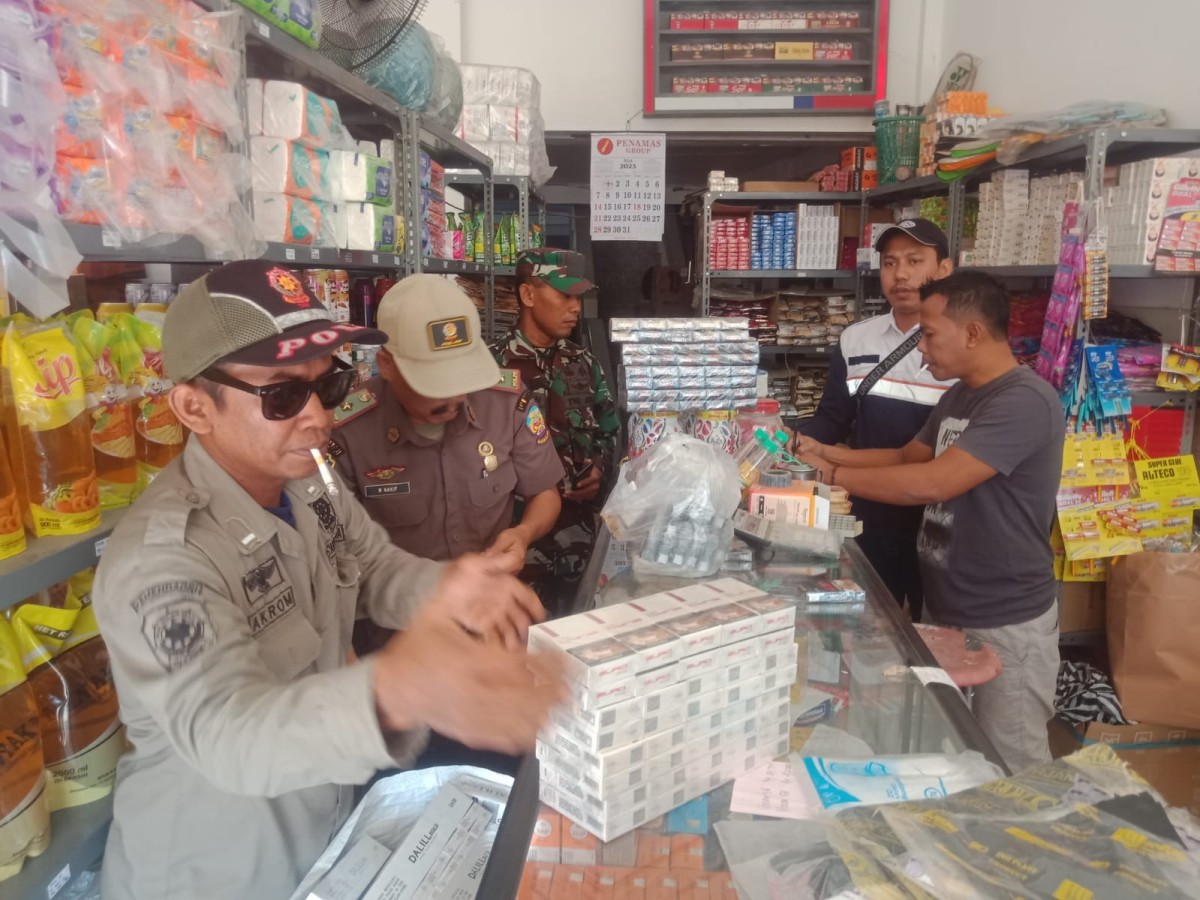 Petugas gabungan merazia toko yang diduga menjual rokok ilegal.(foto: Eko for jatimnow.com)