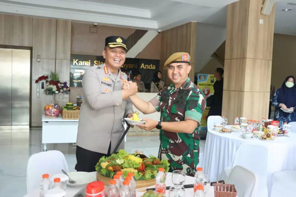 Letkol Arh Iwan Hermaya, P, S. I. P, M. I. P, makan tumpeng bersama Kapolres Sidoarjo, Kombes Pol Kusumo Wahyu Bintoro.  (Foto: Yonarhanud for jatimnow.com)