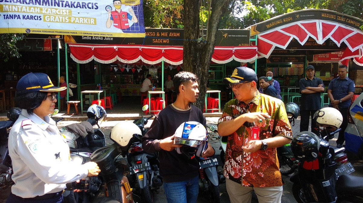 Kepala Dishub Surabaya Tandjung Iswandaru saat melakukan sosialisasi kepada masyarakat agar meminta karci parkir. (Foto: Haryo Agus /jatimnow.com)