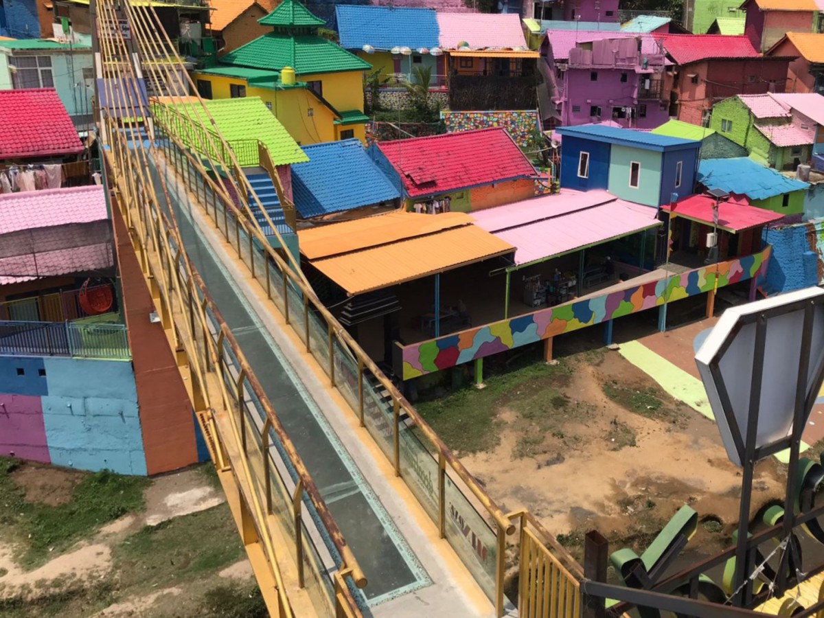 Jembatan kaca yang menghubungkan antara Kampung Warna Warni Jodipan dan Kampung Tridi di Kota Malang. (Foto: Gerhana/jatimnow.com)