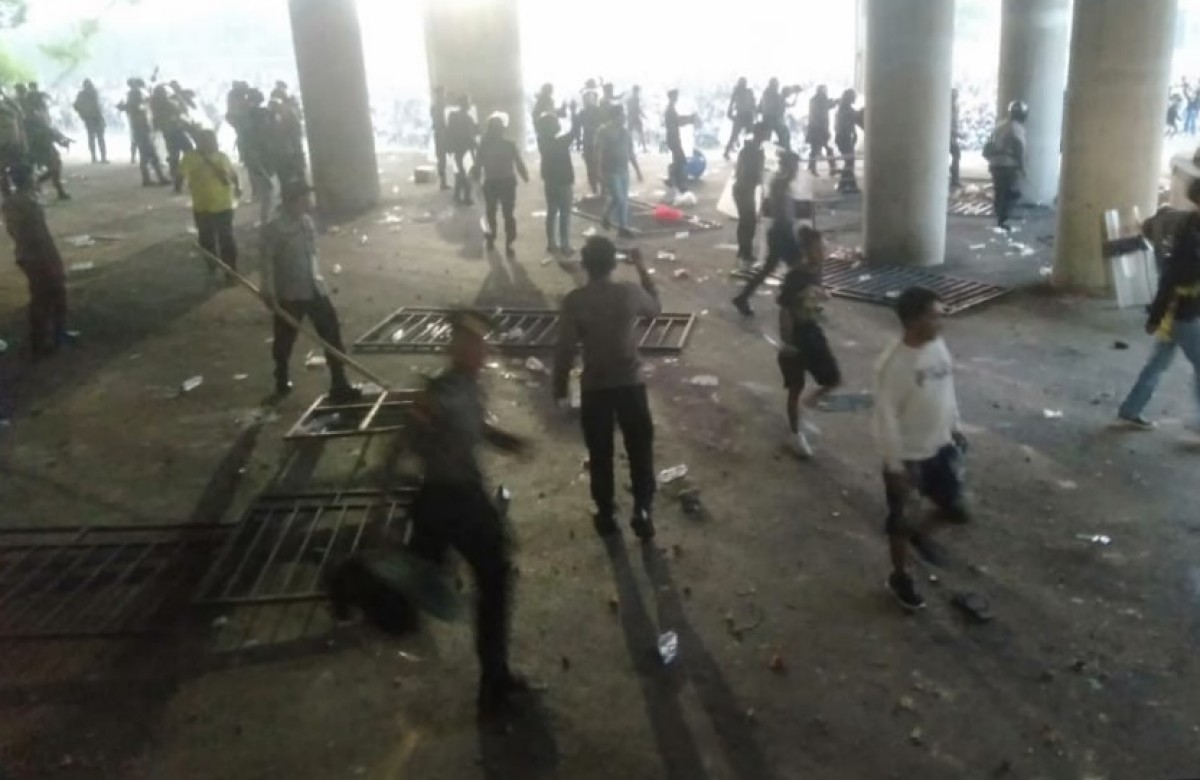 Suporter Gresik United bentrok dengan aparat usai timnya kalah dari Deltras Sidoarjo di Stadion Gelora Joko Samudro. (Foto: Tangkapan layar video amatir)