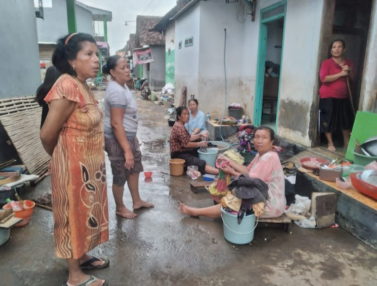 Warga Dringu bersih-bersih perabotan rumah usai diterjang banjir. (Foto: Mahfud Hidayatullah/jatimnow.com)