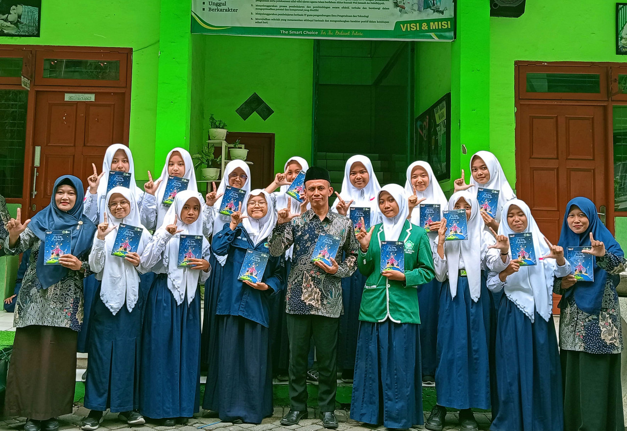 Para murid SMP Buana Waru dengan karya buku antologi cerpen My Teacher My Guiding Star. (Foto: Ahaddiini HM/jatimnow.com)