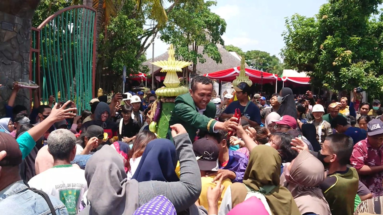 Warga saat berebut tumpeng dalam upacara tradisi bersih nagari. (Foto: Bramanta Pamungkas/jatimnow,com)