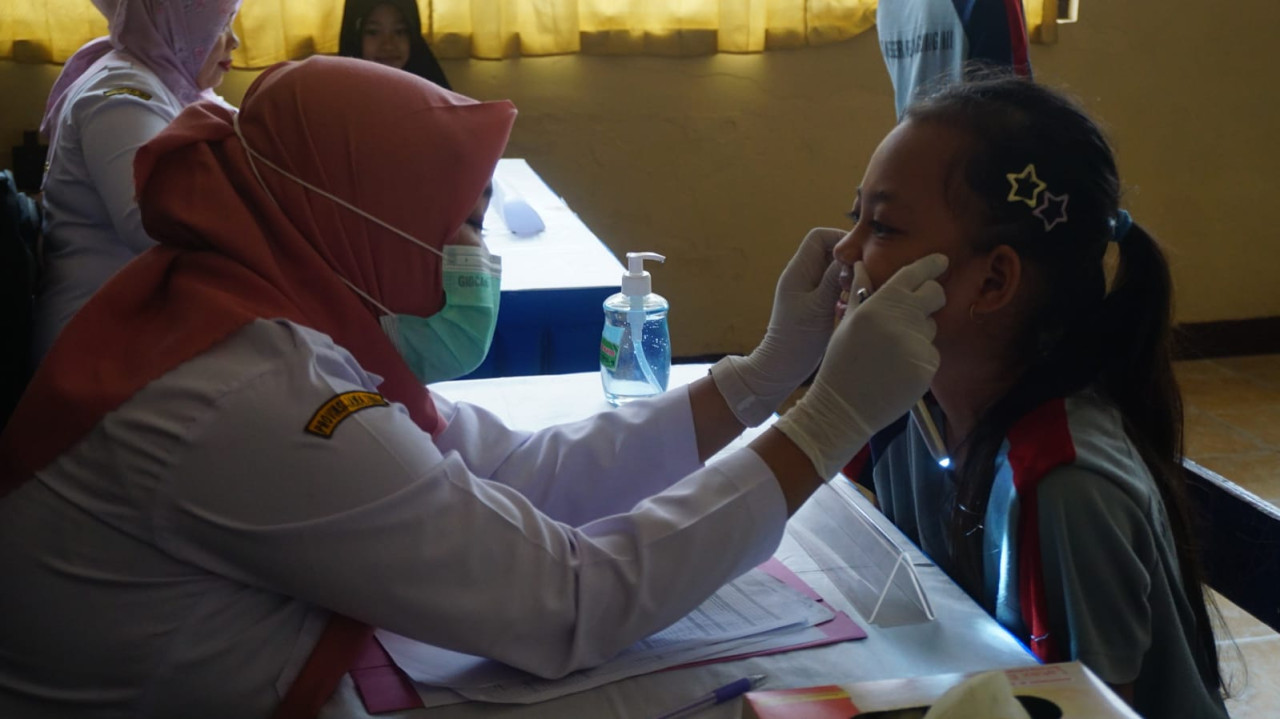 Foto: Petugas memeriksa kesehatan siswa di Tulungagung (Bramanta/jatimnow.com)