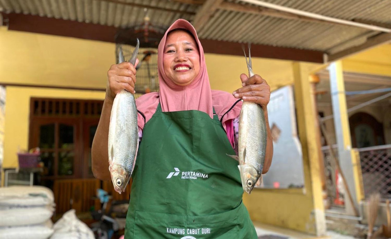 Pelaku UKM menunjukkan ikan bandeng, dalam acara peluncuran Usaha Kecil Menengah (UKM) "Kampung Cabut Duri" (KUCARI) di RT 17 RW 04 Desa Kalanganyar. Foto: Pertamina for JatimNow.com