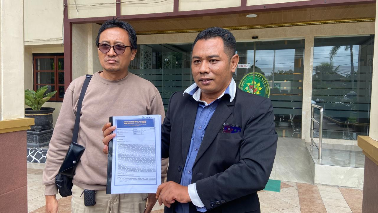 Kuasa hukum penggugat menunjukkan surat gugatan usai sidang perdana di Pengadilan Negeri Kabupaten Kediri. (Foto: Yanuar Dedy/jatimnow.com)