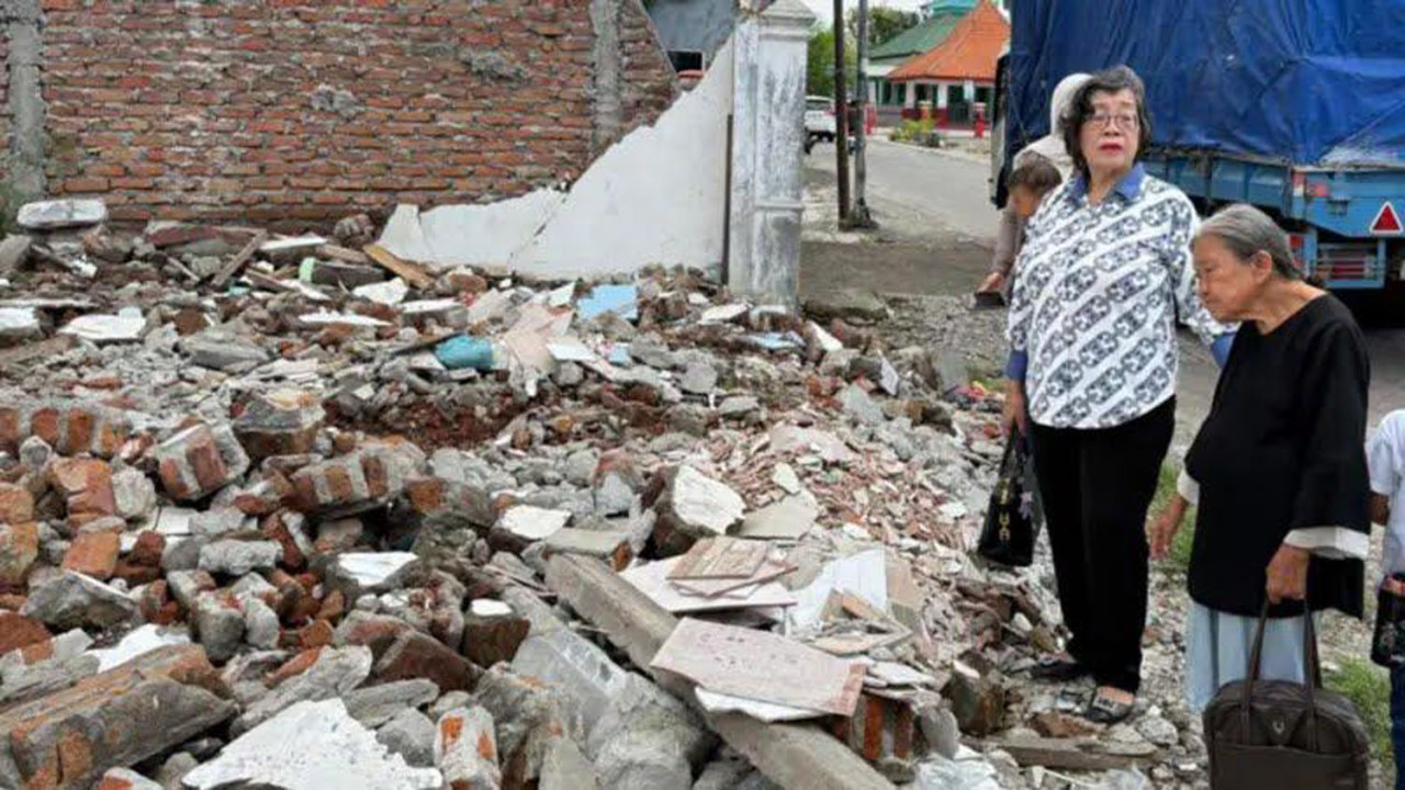 Nenek Elina melihat puing-puing bekas rumahnya. (Foto/WAG)