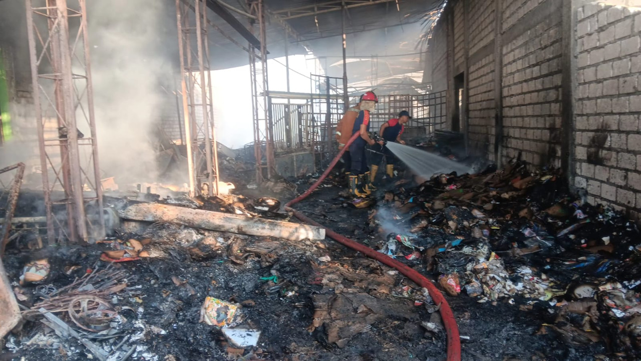 Proses pemadaman di gudang rongsokan Lamongan. (Foto : Damkar Lamongan for jatimnow.com)