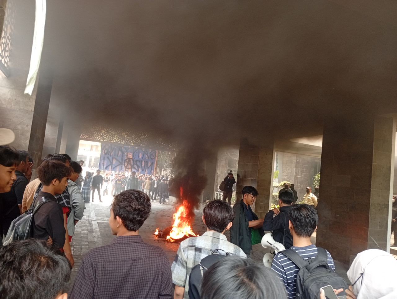 Mahasiswa UINSA menyalakan api dan mengepung Gedung Rektorat UINSA (foto: Nur Ifansyah/jatimnow.com)