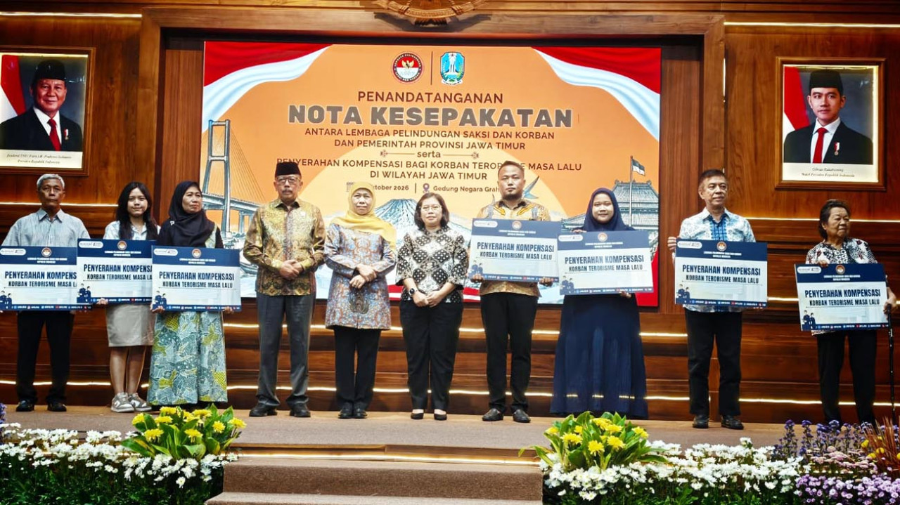 Ketua LPSK Achmadi dan Gubernur Jatim Khofifah Indar Parawansa, foto bersama usai penyerahan kompensasi negara kepada korban serangkaian ledakan bom di Surabaya. (Foto: Ali Masduki/jatimnow.com)