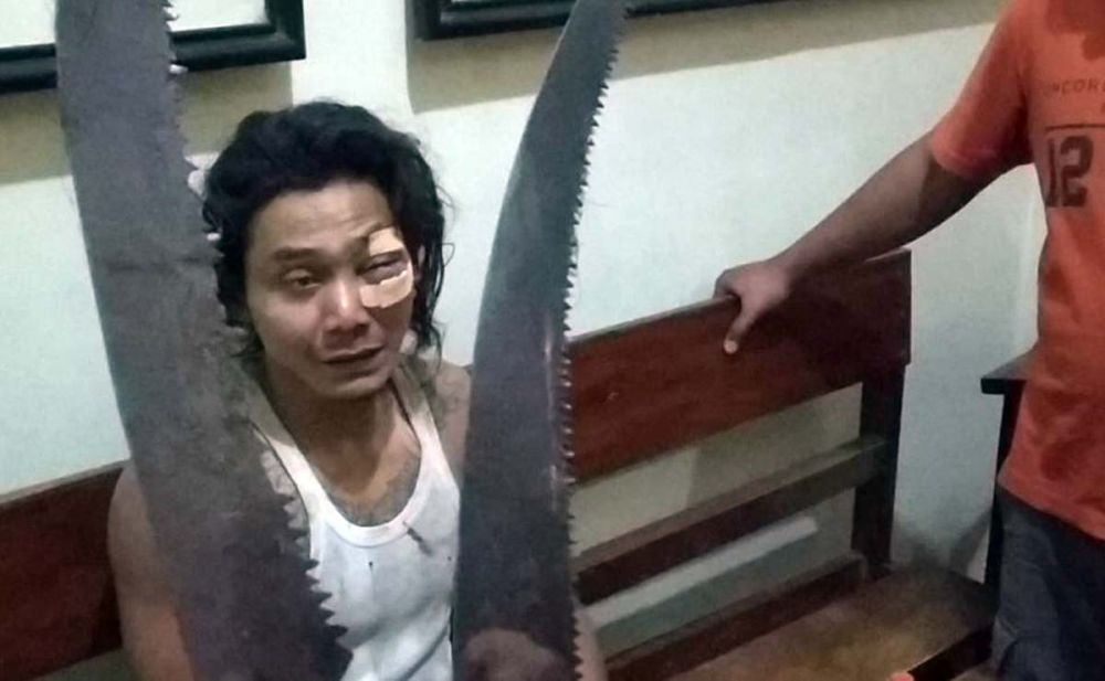 Heri Susanto diamankan bersama gergaji tangan yang dipakainya untuk membacok ibu kandungnya
