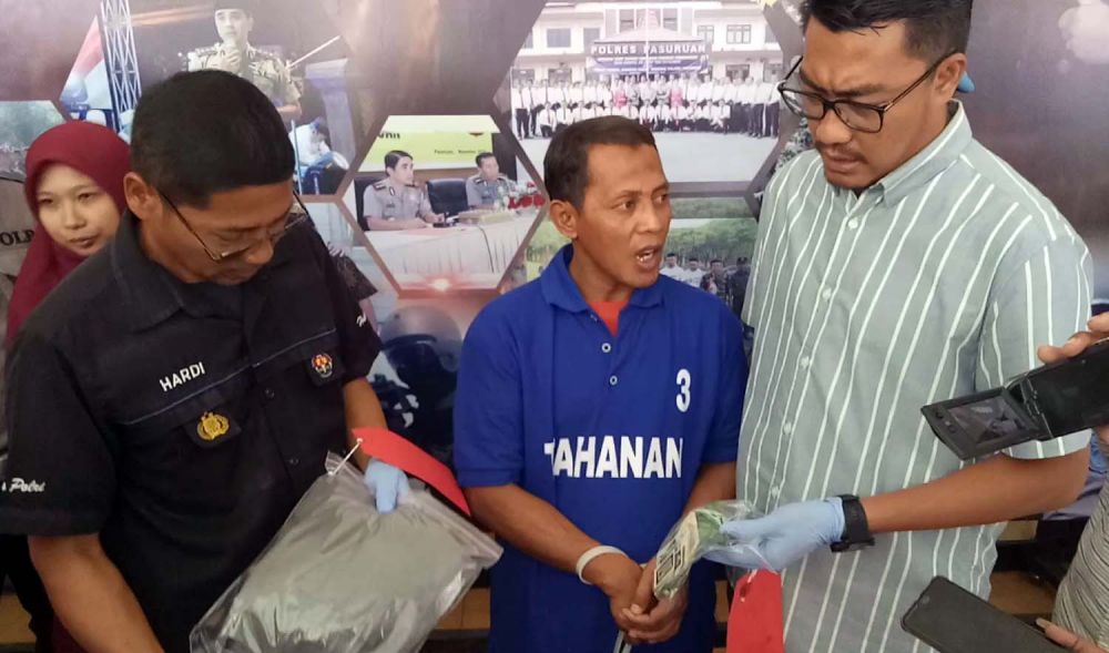 Kasatreskrim Polres Pasuruan AKP Adrian Wimbarda (kanan) menunjukkan pelaku sodomi (tengah)