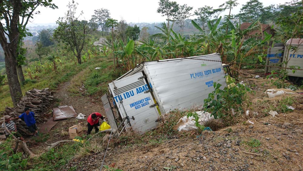 Petugas dari PT Putra Restu Ibu Abadi (PT PRIA) saat memindahkan limbah medis yang berada dalam truk boks./ Foto: Khilmi Sabikhisma Jane. 
