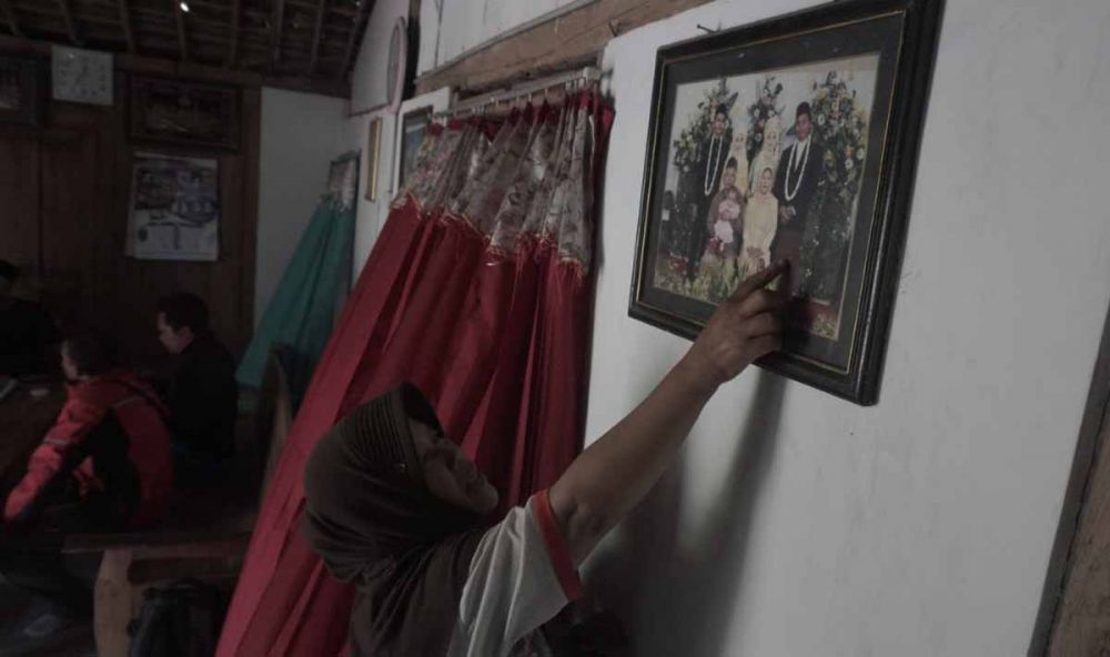 Keluarga menunjukkan foto menantunya Nur Rohman dan Dewi anaknya yang eksodus dari Ngawi ke Malang