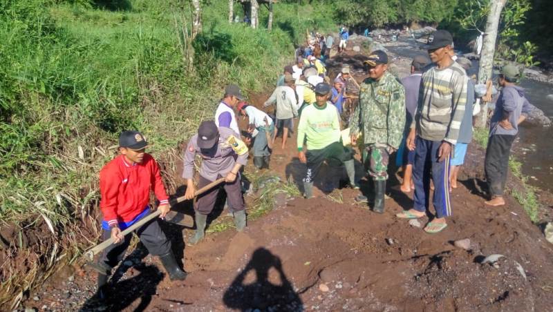 Warga bersama Polisi dan TNI saat gotong royong bersihkan material di saluran irigasi/Foto: Irul Hamdani
