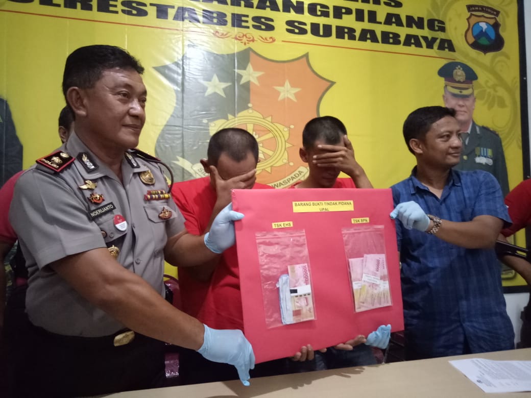 Petugas menunjukkan barang bukti uang palsu