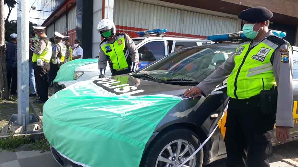 Pemasangan masker besar di mobil lalu lintas oleh Polsek Sukolilo