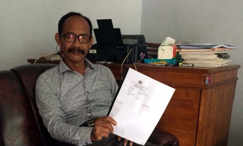 Edy Subiyanto menujukkan surat laporan polisi kasus dugaan pungli PTSL yang dilaporkannya ke Polresta Banyuwangi