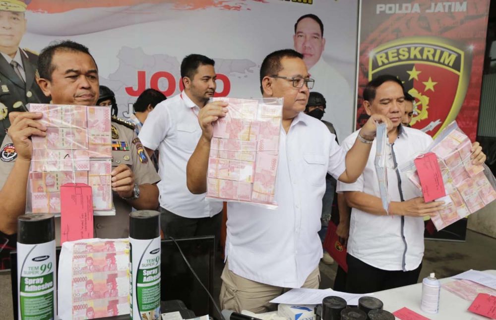 Kapolda Jawa Timur Irjen Pol Luki Hermawan menunjukkan uang palsu yang dibuat dari diedarkan dua tersangka asal Jember