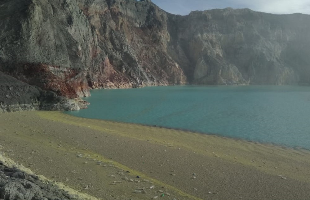 Sampah botol plastik berserakan di tepi danau Kawah ijen. 