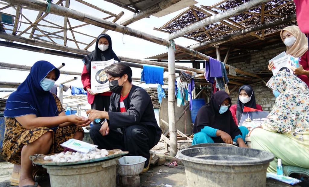 Para mahasiswa FIK UMSurabaya memberikan edukasi prokes ke warga pesisir Sukolilo