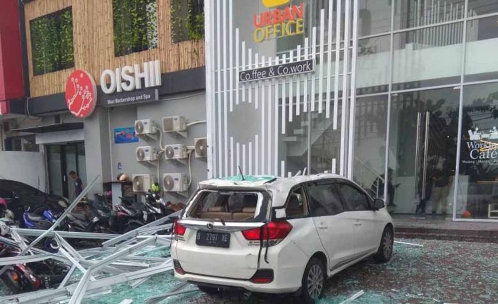Honda Mobilio yang rusak parah tertimpa reruntuhan partisi alumunium dan kaca di sebuah Ruko di Jalan Ir Soekarno