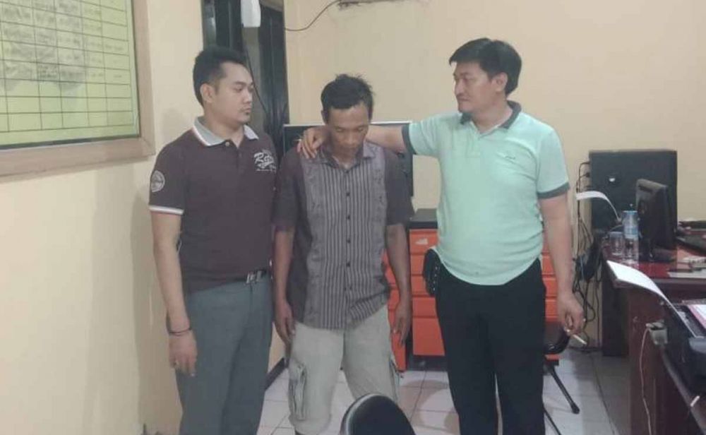 Tasim (tengah) ditangkap polisi setelah mencuri kayu lima kali