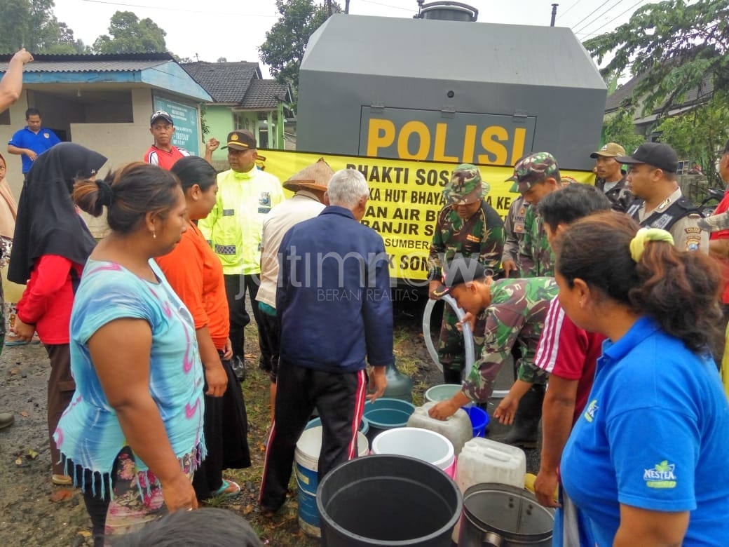 Petugas membagikan air bersih dari mobil water canon./Foto: Irul Hamdani.