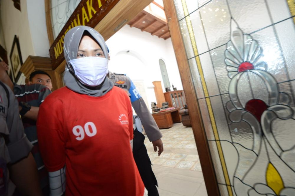 Zikria, pemilik akun Facebook penghina Wali Kota Risma saat digiring di Mapolrestabes Surabaya 