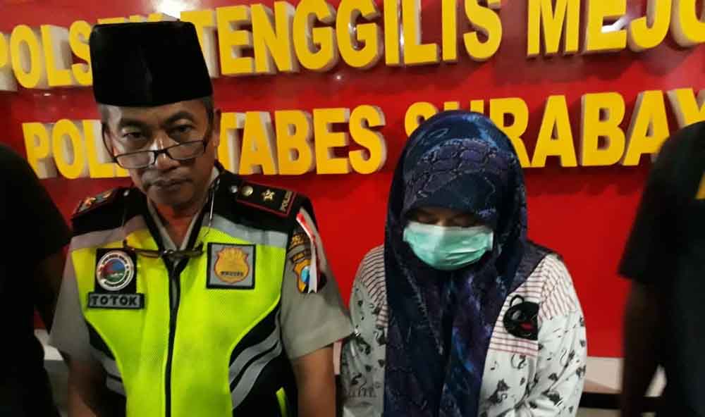 Tersangka (berkerudung) saat berada di Mapolsek Tenggilis Surabaya