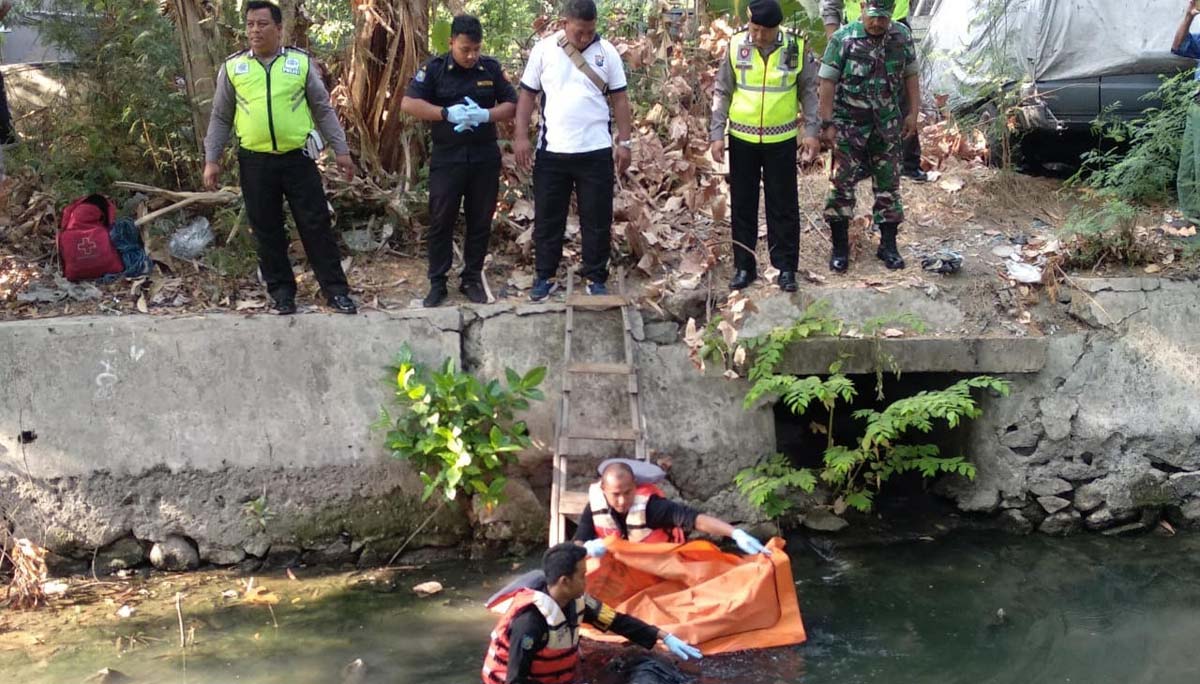 Petugas mengevakuasi jasad Suwono dari Sungai Kalibokor Surabaya.