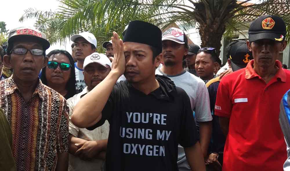 Ali Mustofa, pemilik rumah (tengah) terlihat mengusap air matanya