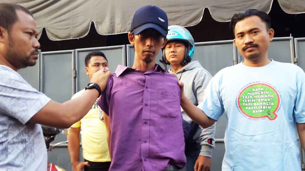 Wahid saat digelandang petugas kepolisian