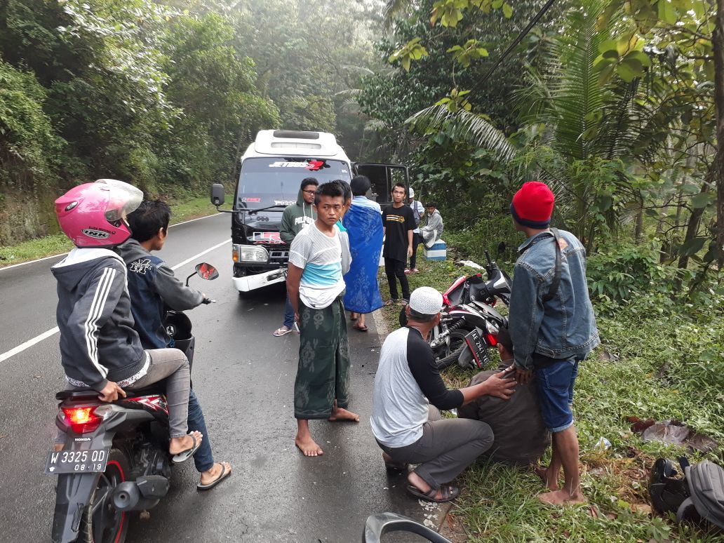 Seorang biker yang kritis dibantu oleh warga.