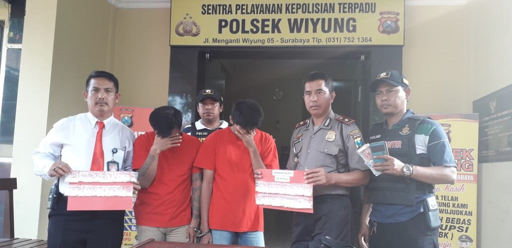 Kapolsek Wiyung Kompol M Arsyad menunjukkan barang bukti beserta kedua tersangka.
