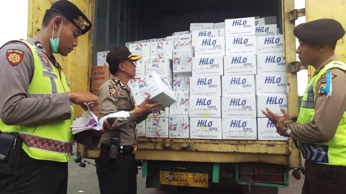 Petugas Polres Pelabuhan Tanjung Perak memeriksa muatan truk.