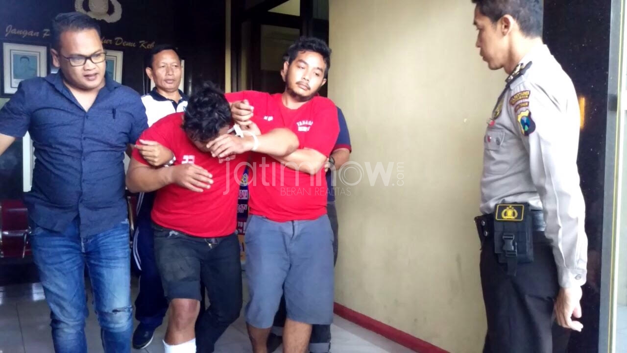 Rommy (kaki diperban) meringis kesakitan saat digelandang ke gelar ungkap kasus./Foto: Narendra Bakrie.

