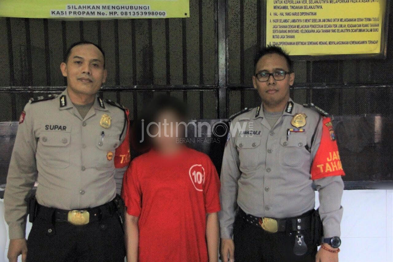 Ayuk (tengah) saat diamankan di Mapolrestabes Surabaya.
